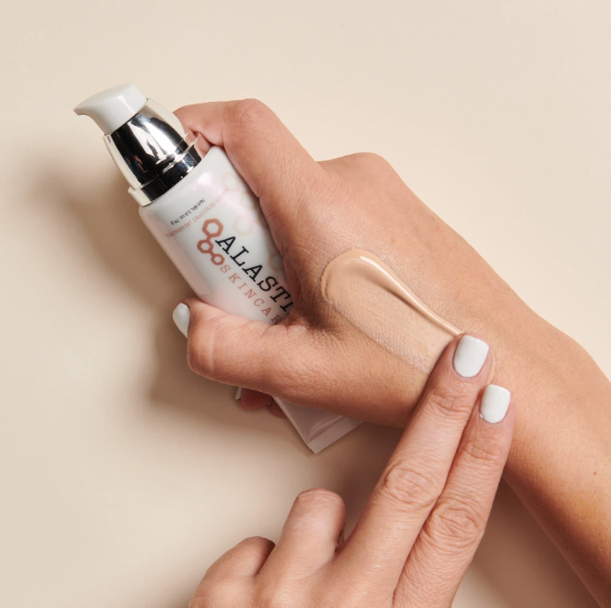 ALASTIN Skincare HydraTint Pro Mineral Broad Spectrum SPF 36 (3.2 oz) on a model's hand
